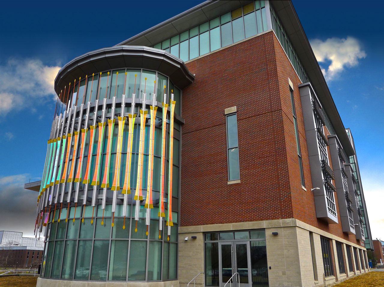 Rohrer College of Business at Rowan University exterior view of Threshold laminated dichroic glass and perforated stainless steel sculpture abstractly refers to gate imagery. | Image 3 | Ed Carpenter, Artist