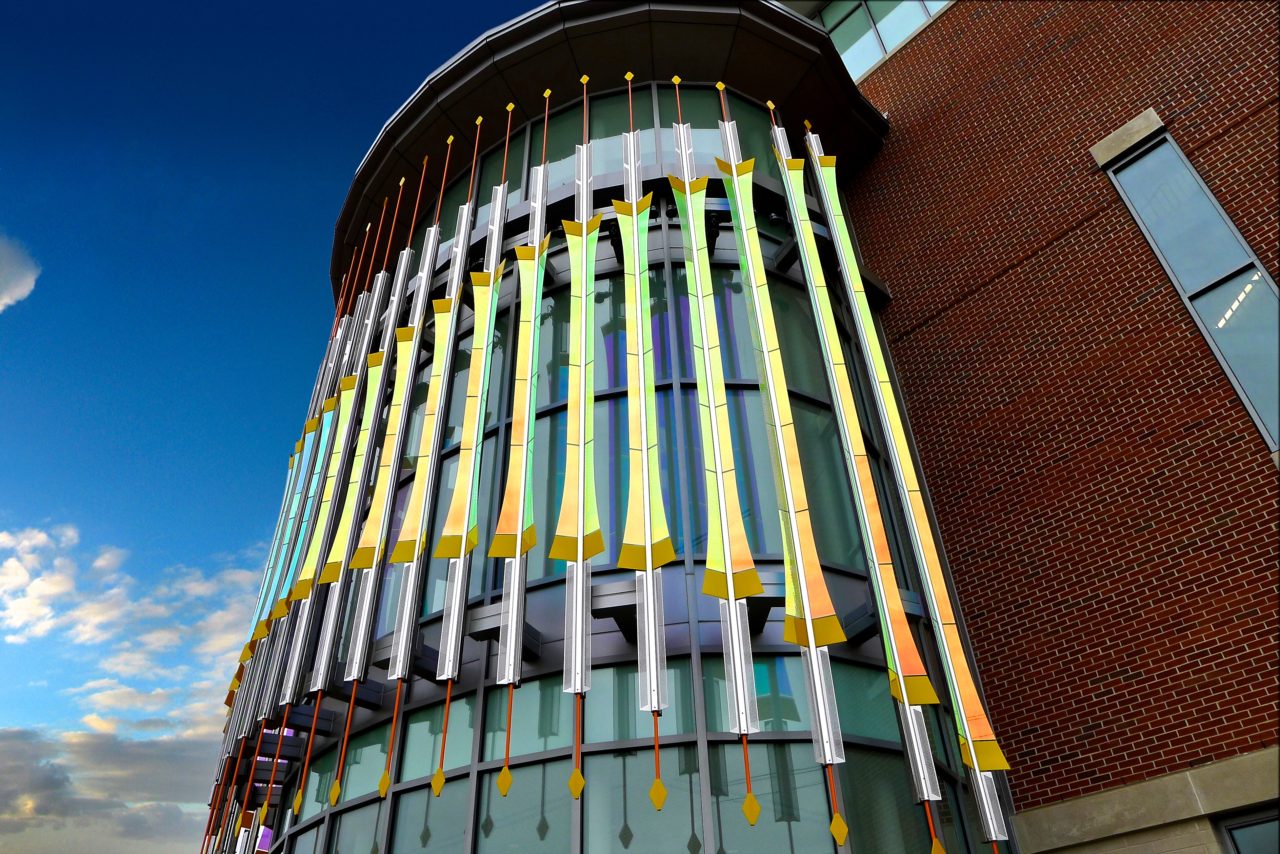 Rohrer College of Business at Rowan University close up of side view of Threshold laminated dichroic glass and perforated stainless steel sculpture showing dichroic glass detail. | Image 4 | Ed Carpenter, Artist