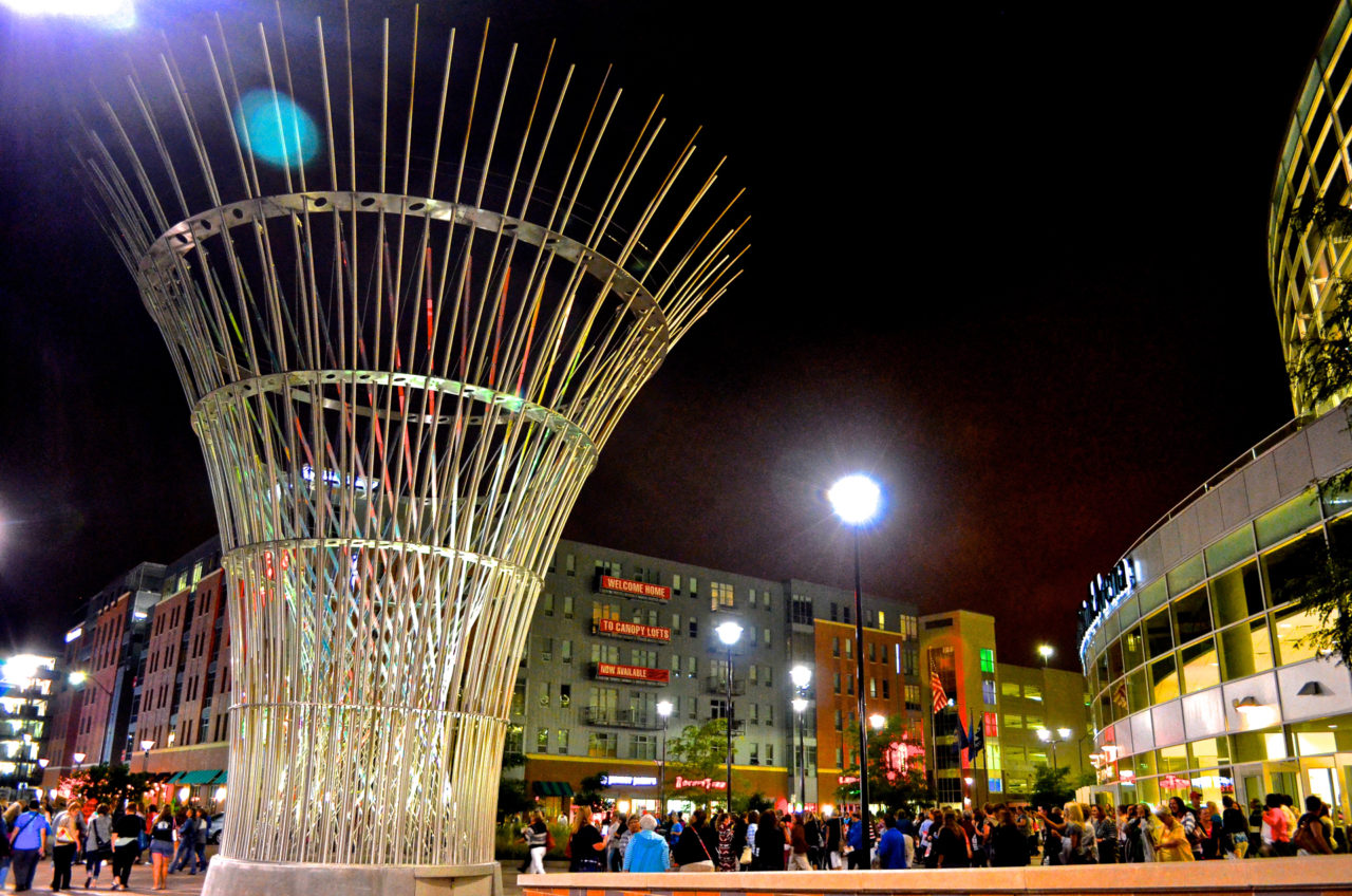 Harvest monumental public sculpture in Lincoln, Nebraska with night lighting in the evening after the game, crowds meet in the plaza celebrating victory. | Image 6 | Ed Carpenter, Artist