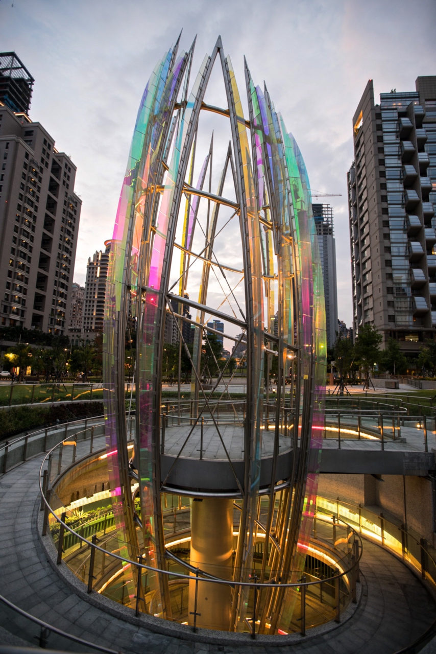 Taichung, Taiwan Civic Center monumental sculpture: Stainless Steel and Laminated Dichroic Glass. Crocus emerges from two levels of parking below the parks, surrounds a viewing platform, and unfolds upward like an enormous blossom. | Image 6 | Ed Carpenter, Artist