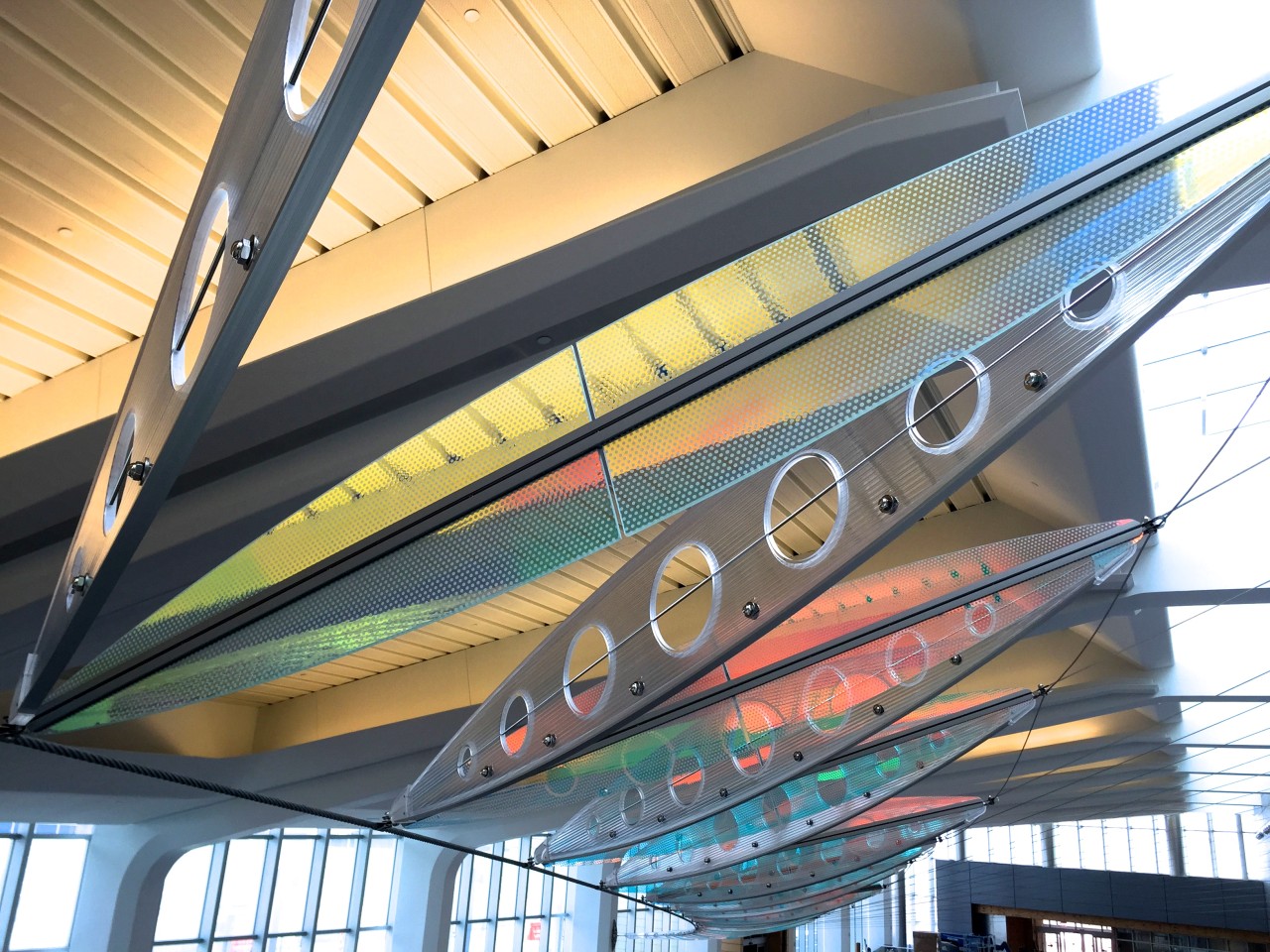 Ed Carpenter’s Wichita Dwight D. Eisenhower National Airport signature sculpture Aloft delights travelers with colorful laminated safety dichroic glass above. | Image 14 | Ed Carpenter, Artist
