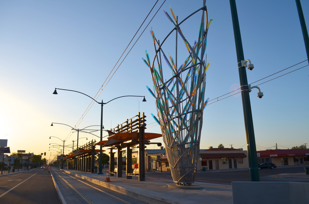 Ed Carpenter’s Mesaflora Mesa AZ sculpture in the early morning marks the way for light rail commuters. | Image 2 | Ed Carpenter, Artist