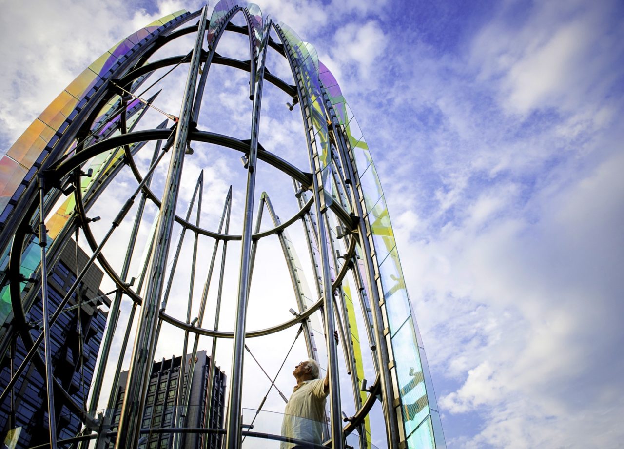 Taichung, Taiwan Civic Center monumental sculpture: Stainless Steel and Laminated Dichroic Glass. Upward view of the sculpture Crocus with artist, Ed Carpenter. | Image 9 | Ed Carpenter, Artist