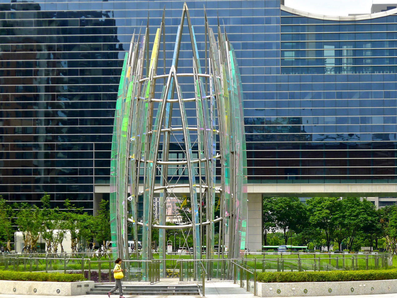 Taichung, Taiwan Civic Center monumental sculpture: Stainless Steel and Laminated Dichroic Glass. During the day, light plays off polished surfaces of stainless steel and laminated glass of the sculpture, Crocus. / image 3